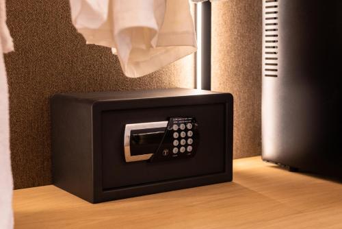 a tv with a remote control sitting on top of it at Chora Suites, Premium Key Collection in Skiathos Town