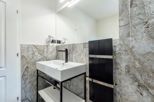 a bathroom with a white sink and a mirror at Apartments Belani Zelenika in Španjola