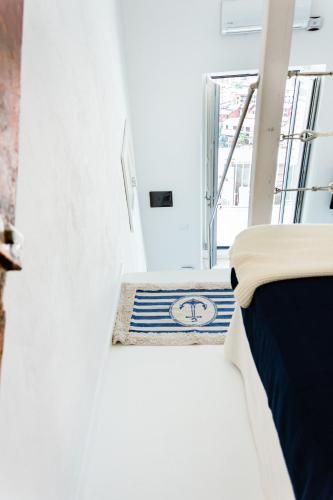 a bedroom with a bed and a blue and white rug at Dimora Cavour in Amantea