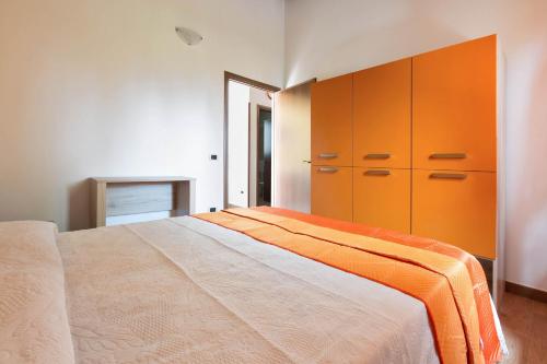 a bedroom with a large bed and orange cabinets at Dependance di Villa Dea by BarbarHouse in Matino