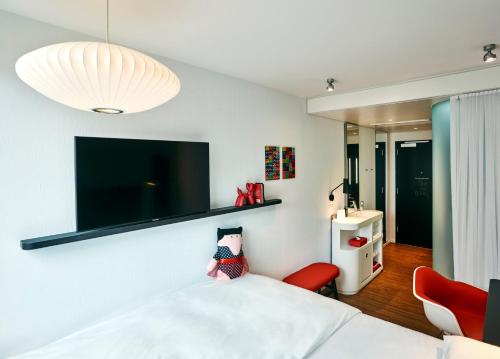 1 dormitorio con 1 cama y TV en la pared en citizenM Miami Brickell en Miami
