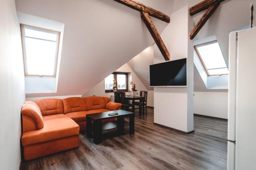 a living room with a couch and a tv at Villa u Arény in Ostrava