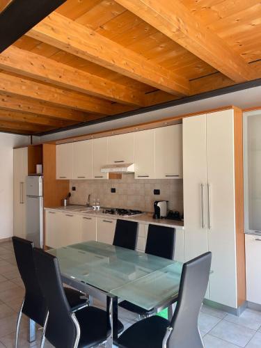 a kitchen with a table and chairs in a room at Easy Milano - Rooms and Apartments Navigli in Milan