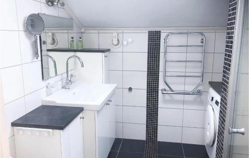 a white bathroom with a sink and a shower at Beautiful Home In Henn With Kitchen in Henån