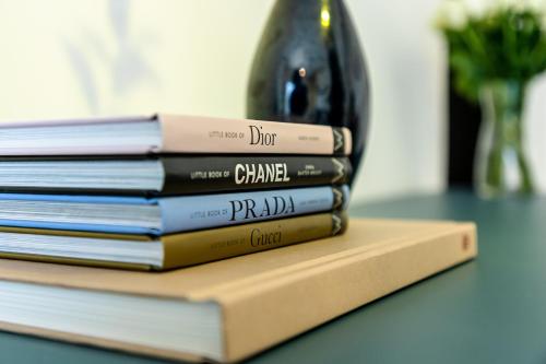 a stack of books sitting on a table at Unlock Metropolis Business Bay in Dubai