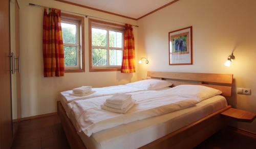 a bedroom with a large white bed with towels on it at Haus Norway Oslo in Wittenbeck
