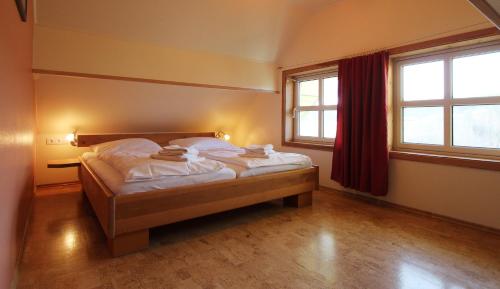 um quarto com uma cama e duas janelas em Haus Norway Trondheim em Wittenbeck