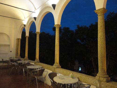 a row of tables and chairs in a building at Hotel Solar de Monfalim in Évora