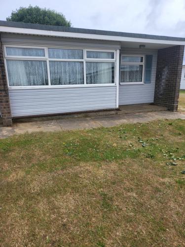 a white house with windows and a yard at The Bobbers in Great Yarmouth