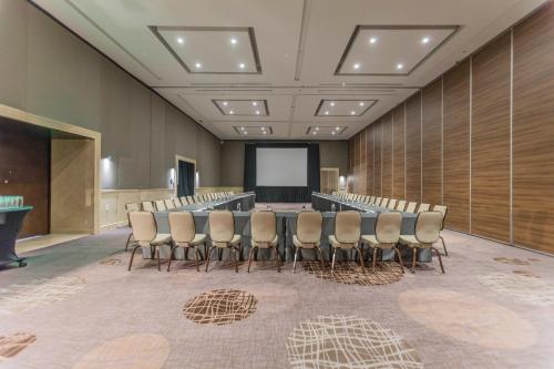 a conference room with a table and chairs and a screen at Presidente InterContinental Mexico City by IHG in Mexico City