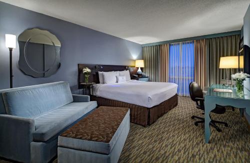 a hotel room with a bed and a desk at Crowne Plaza Chicago O'Hare Hotel & Conference Center by IHG in Rosemont