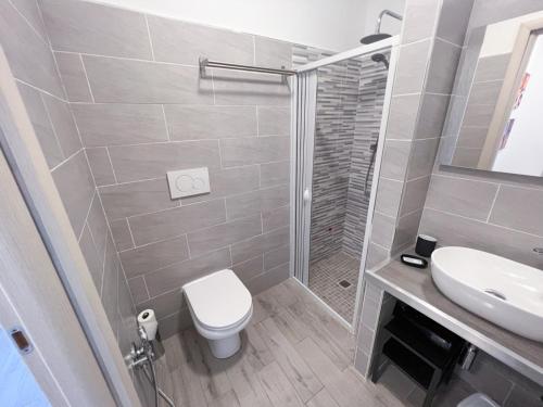 a bathroom with a toilet and a sink and a shower at A casa di Asja in Terni