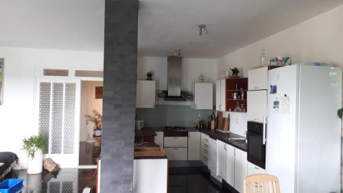 a kitchen with white cabinets and a white refrigerator at B&B Fryden Ly in Horsens