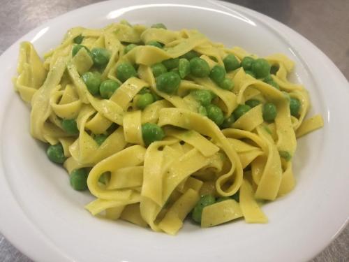 a plate of pasta with peas and green beans at Agriturismo Da Andreina in Borso del Grappa