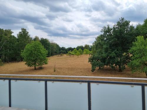a view of a field with trees in the background at Hotel Pasa Paradies KOSTENLOSE PARKPLÄTZE in Hanau am Main