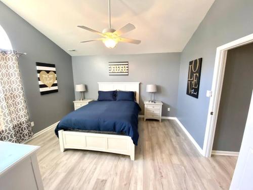 a bedroom with a bed and a ceiling fan at The Best Getaway Friends & Family Hangout!!! in Jacksonville