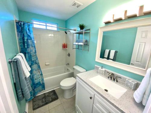 a bathroom with a toilet and a sink and a mirror at The Best Getaway Friends & Family Hangout!!! in Jacksonville