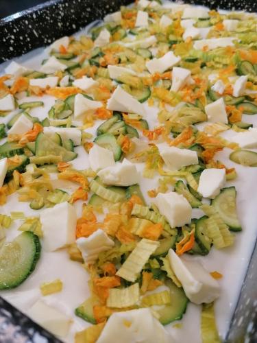 a plate of food with vegetables and cheese at Agriturismo Da Andreina in Borso del Grappa