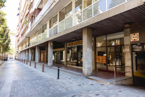 an empty street in front of a building at Bravissimo Eiximenis, with beautiful terrace and views in Girona