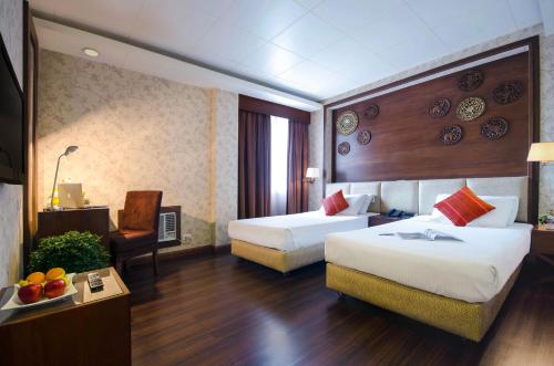 Säng eller sängar i ett rum på Hotel La Corona Manila