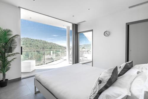 a bedroom with a bed and a large window at Villa des Oliviers in Nice