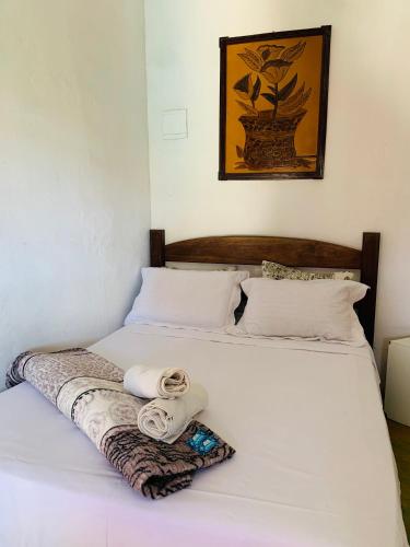 two beds with white sheets and towels on them at Pousada Núcleo da Serra in Serra do Cipo