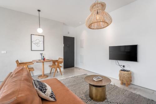 a living room with a couch and a table at Trendy apartment next to Levinsky market in Tel Aviv