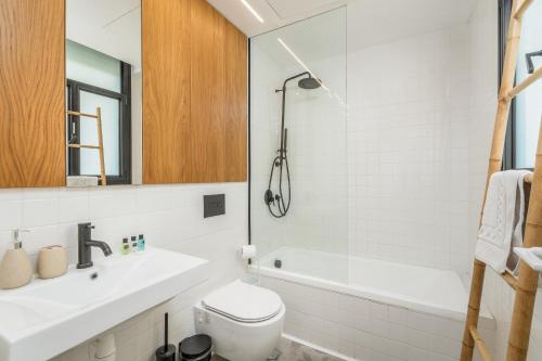 łazienka z umywalką, toaletą i wanną w obiekcie Trendy apartment next to Levinsky market w Tel Awiwie