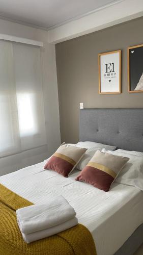 a large white bed with two pillows on it at LD House Flora in Cali