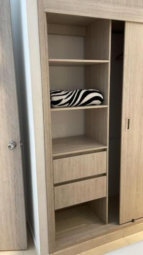 a wooden closet with a zebraebra object in it at LD House Flora in Cali
