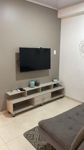 a living room with a flat screen tv on a wall at LD House Flora in Cali