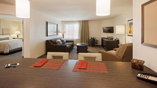 a hotel room with a dining table and a living room at Candlewood Suites Harlingen by IHG in Harlingen