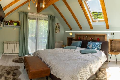 a bedroom with a large bed with green curtains at Vila Rustic INN Bucegi in Pietroşiţa