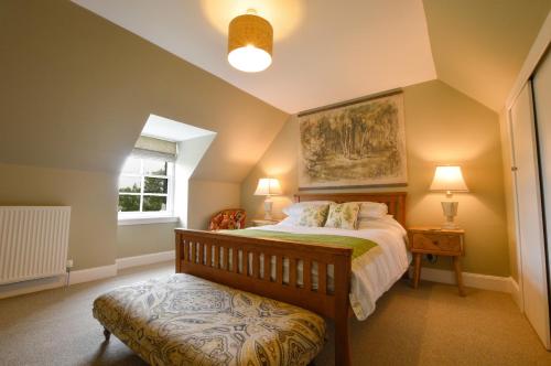 a bedroom with a large bed and a window at Achanlochan Farm in Taynuilt