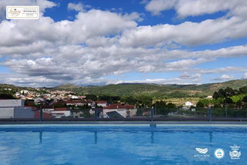 a swimming pool with a blue sky at Boticas Hotel Art & SPA in Boticas