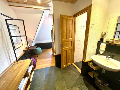 a bathroom with a sink and a mirror at GRAND your home with common kitchens with self check-in in Engelberg