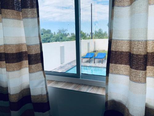 a window with a view of a swimming pool seen at Villa Liam B&B Kiwengwa Zanzibar in Kumba Urembo