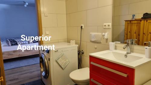 a bathroom with a white toilet and a sink at Ferienwohnung Halle in Halle an der Saale