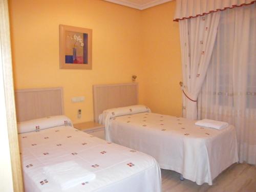 Postel nebo postele na pokoji v ubytování Hostal Dulcinea
