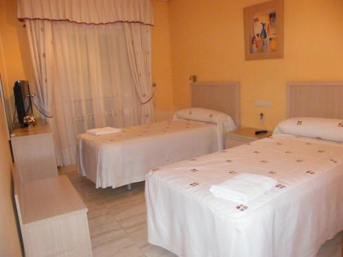 Postel nebo postele na pokoji v ubytování Hostal Dulcinea