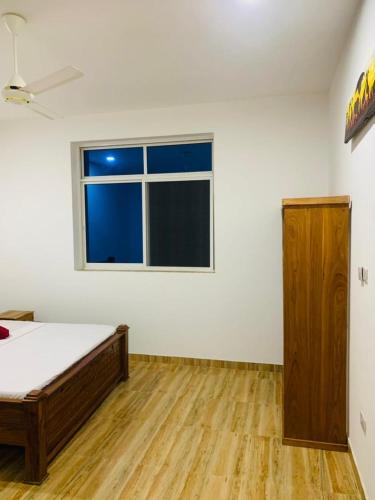 a white room with a bed and a window at Villa Liam B&B Kiwengwa Zanzibar in Kumba Urembo