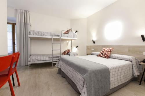 a bedroom with a bed and two bunk beds at Hostal Castilla II Puerta del Sol in Madrid