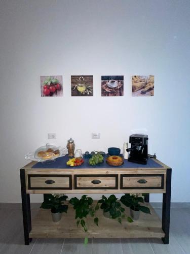 a table with food on it in front of a wall at Anfra B&B in Naples