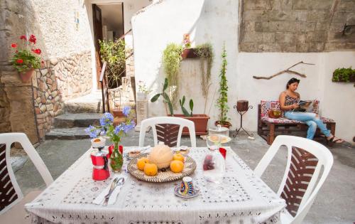 a woman sitting at a table with a plate of food at Profumo di Zagara in Lentini