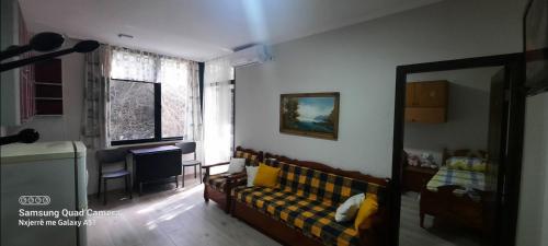 a living room with a couch and a window at Pine Apartment 2 plus 1 in Golem
