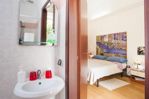 a bathroom with a sink and a bed in a room at Profumo di Zagara in Lentini