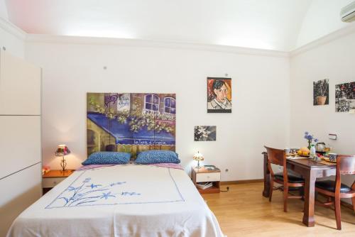 a bedroom with a bed and a table and a desk at Profumo di Zagara in Lentini