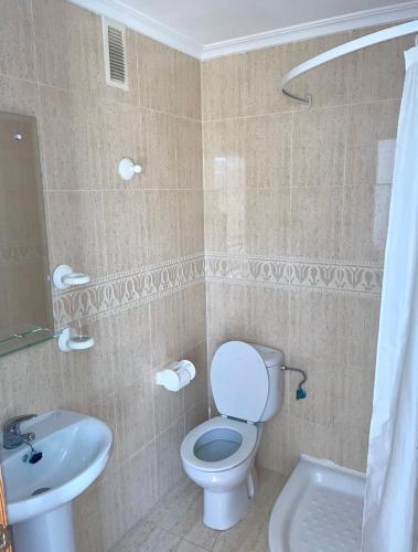 a bathroom with a toilet and a sink at 2 bedroom Duplex Apartment Playa Flamenca in Orihuela Costa