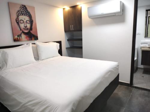Postel nebo postele na pokoji v ubytování Hotel Qatar Cali
