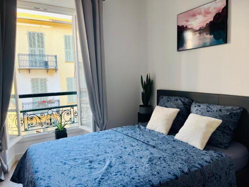 a bedroom with a bed and a large window at NICE - Central 100m plage- Negresco - IDEAL COUPLE in Nice